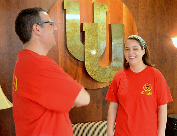 Dr. Keith Bates and Emily Littleton share a light moment together following a Phi Alpha Theta group photo session for the Delta-Psi chapter's Red T-shirt Spirit Day on April 13, 2015. Photo by Emily Stookey