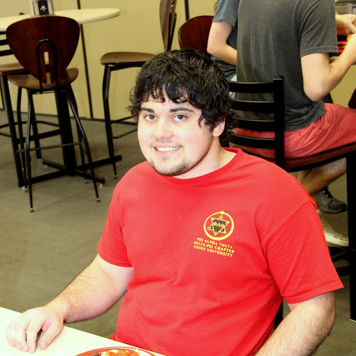Phi Alpha Theta chapter member Ashton Hostetler pauses during lunch in Union's cafeteria for a photo wearing his Delta-Psi chaper T-shirt on April 13, 2015.