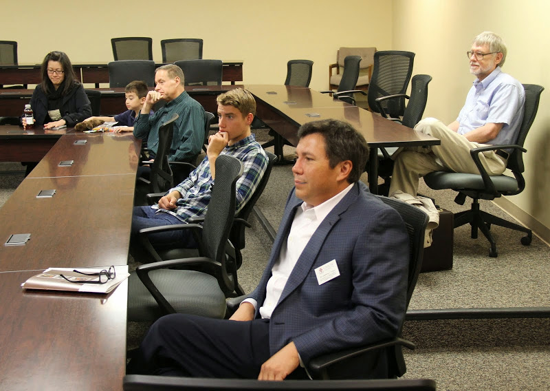 Attendees listen intently as Faith Bagley presents her paper