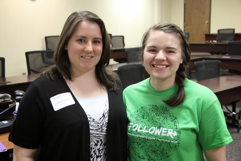 History majors Faith Bagley (left) and Jordan Sellers share a moment together following Bagley's presentation on Civil War prison camps at the Union University Scholarship Symposium on April 28, 2015.