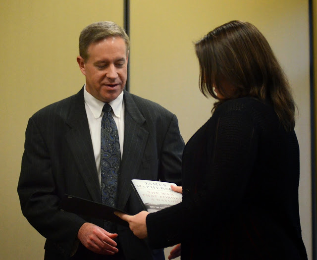 Dr. Henry Allen presents a certificate of recognition and a book to Faith Bagley at the history awards banquet on April 30, 2015, for her paper presentation at the Tennessee Phi Alpha Theta Regional Conference in February.  Photo by Emily Stookey