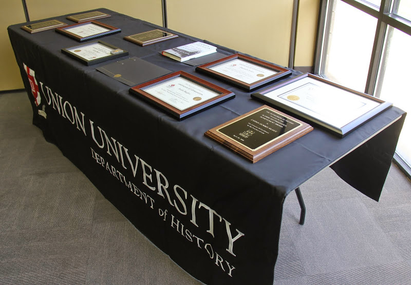 Awards fill a department table at the history awards banquet on April 30, 2015.