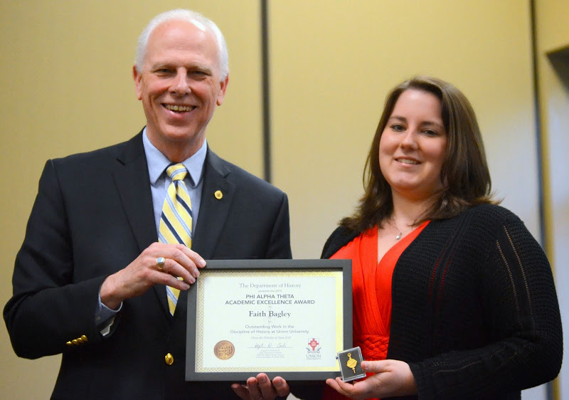 Faith Bagley accepts the Phi Alpha Theta Scholarship Pin and Certificate of Academic Excellence from Dr. Stephen Carls at the history awards banquet on April 30, 2015.  Photo by Emily Stookey