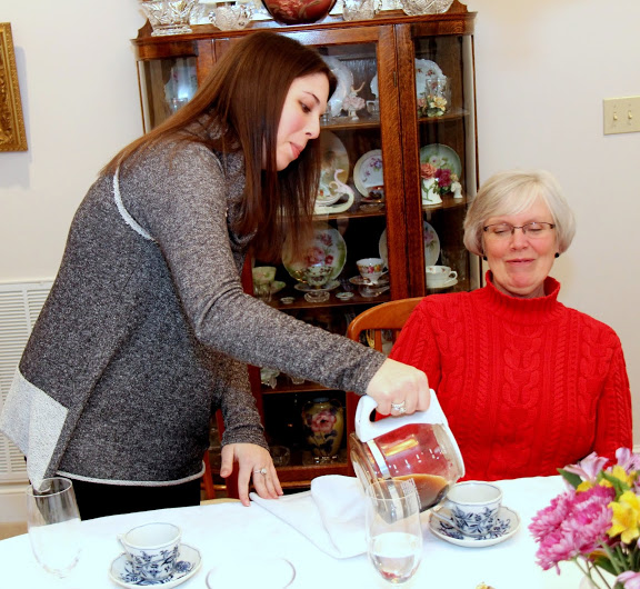 Caitlin Roach pours coffee for Nancy Thomas