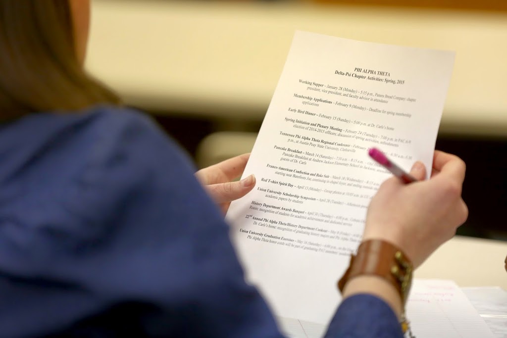 Phi Alpha Theta secretary Sarah Carroll takes a look at the Delta-Psi chapter's list of activities for the spring semester at the society's meeting on February 24, 2015.  Photo by Kristi Woody