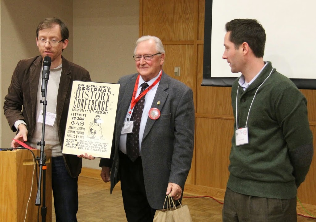 Tennessee Phi Alpha Theta conference co-chair Dr. Jason Verber (left) presents a gift to luncheon keynote speaker Dr. Graydon Tunstall (center) as an expression of appreciation for his luncheon talk. Tunstall's son Allen is on the right.
