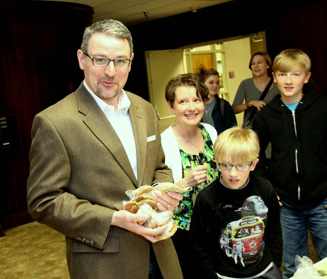 Dr. Keith Bates (left) prepares to pay for his cookie purchases at the 12th Annual Franco-American Confection and Bake Sale on March 18, 2015.