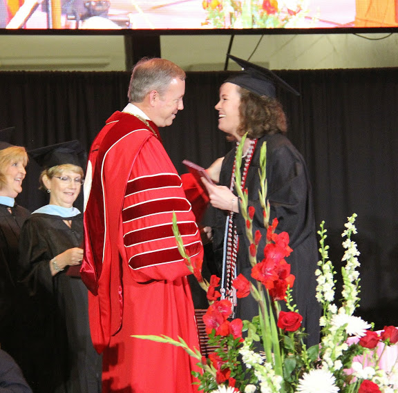 Sarah Carroll, a double major in history and political science, accepts congratulations from Union University President Dr. Samuel W. Oliver as she receivs her diploma at Union University's spring graduation on May 16, 2015.