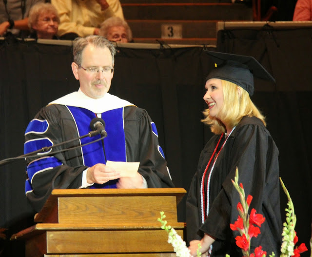 History major and Phi Alpha Theta member Hannah Jones waits for Dr. John Netland, Dean of the School of Arts and Sciences, to announce her as the next recipient of a diploma at Union University's graduation exercises on May 16, 2015.