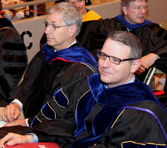 History professors David Thomas (left) and Keith Bates wait for Union's spring graduation to begin at the Oman Arena on May 16, 2015.