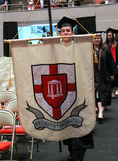 Senior Class President William A. Duncan leads the processional at Union University's spring graduation on May 16, 2015. Visible immediately behind him is history major Faith Bagley who wears her Phi Alpha Theta honor cord.