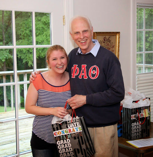 Dr. Stephen Carls presents an award bag to graduating history major and Phi Alpha Theta member Hannah Jones at the history department's annual cookout on May 8, 2015.