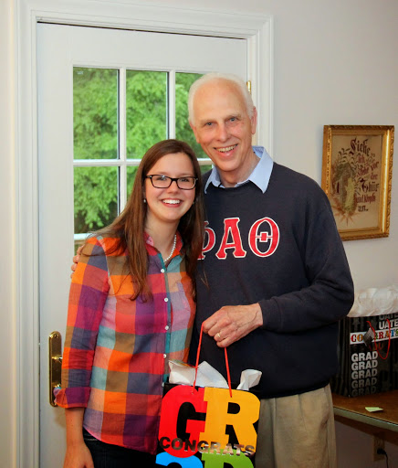 Dr. Stephen Carls presents a graduation award bag to Phi Alpha Theta member Bree McCuin during a program honoring history students at the 23rd Annual Phi Alpha Theta/History Department Cookout on May 8, 2015.