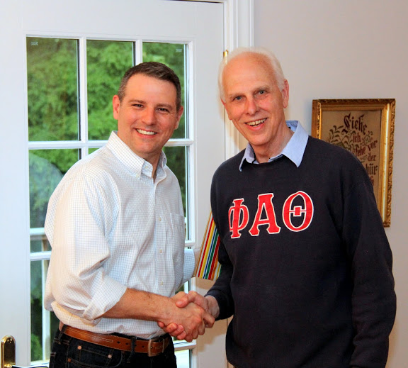 Dr. Keith Bates (left) accepts congratulations from Dr. Stephen Carls at the annual Phi Alpha Theta cookout on May 8, 2015, for his promotion from the rank of associate professor to professor of history.