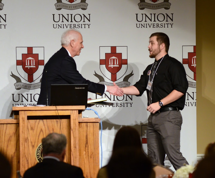 Union's Dr. Stephen Carls (left) congratulates Zachary Hammons of Tennessee Technological University on winning first place in the undergraduate paper competition for world history at the Phi Alpha Theta regional conference on April 2, 2016. Hammons' paper was entitled The Jewish-Roman War of 66-73 CE: A New Analysis of Cause and Effect. Photo by MiKalla Cotton