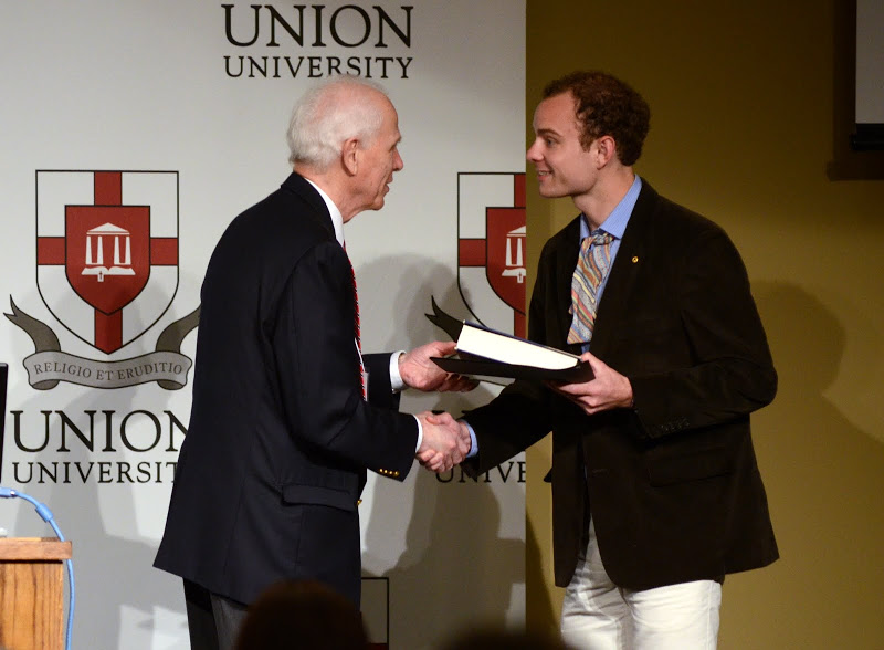 Dr. Stephen Carls presents the first place award in the undergraduate paper competition for American history to Jordan Heykoop of Belmont University at the Phi Alpha Theta regional conference on April 2, 2016. Photo by MiKalla Cotton