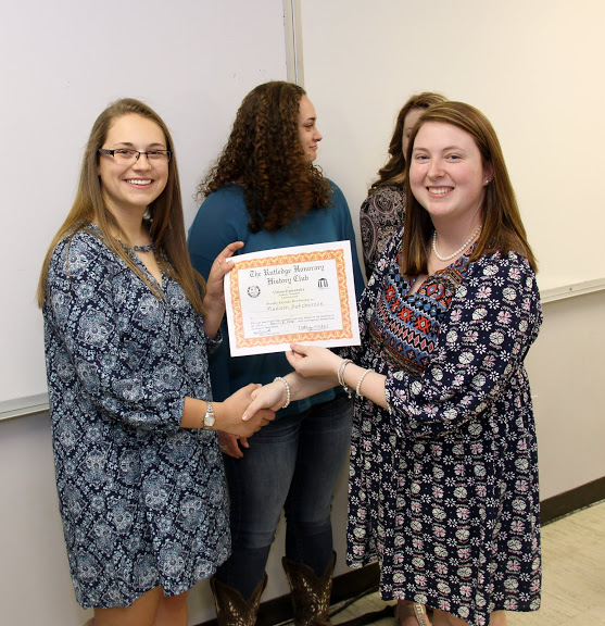Rutledge Honorary History Club President Kathryn Mitchell (right) presents a club membership to newly inducted member Madison Hutcherson at the club's spring plenary meeting on April 5, 2016.
