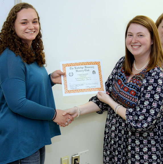 Newly inducted history club member Samantha Daily (left) accepts congratulations from Rutledge Honorary History Club President Kathryn Mitchell at the club's spring plenary meeting on April 5, 2016.