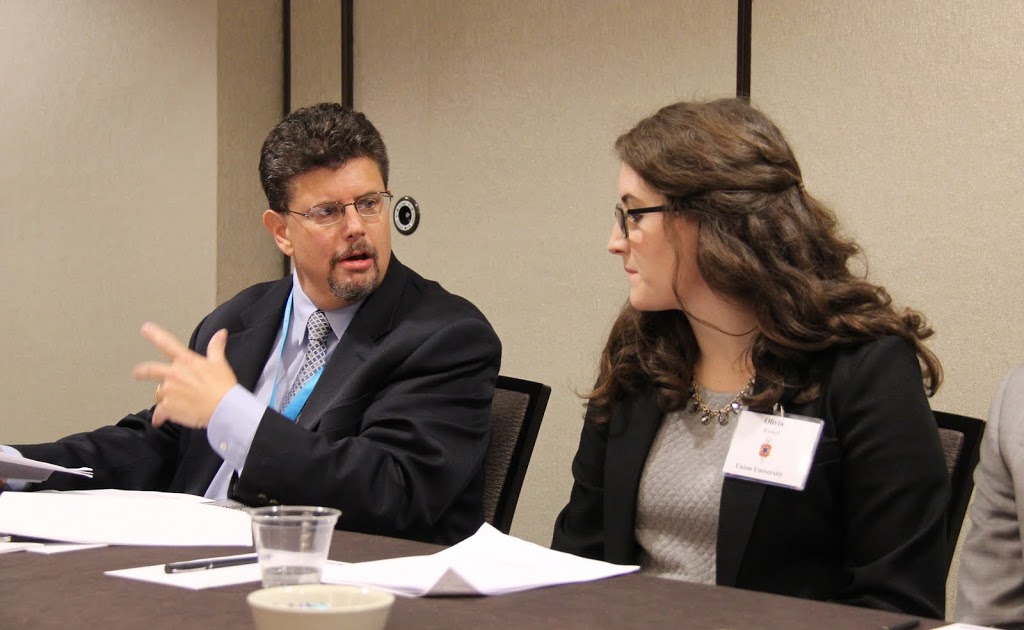 Olivia Winters listens as Dr. Christopher Kennedy comments on her paper titled A Trio of Death: Yellow Fever Epidemics in Memphis at the 2016 Phi Alpha Theta Biennial Convention in Orlando, Florida.