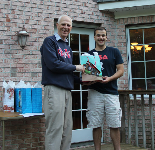 Allen Bradley (right) accepts a graduation bag from Dr. Stephen Carls at the Phi Alpha Theta cookout on May 13, 2016.