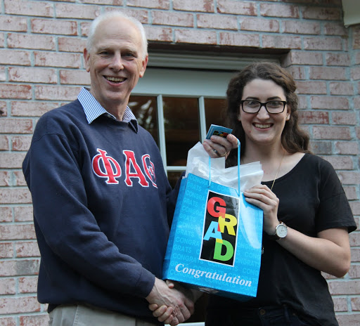 Dr. Stephen Carls congratulates Olivia Winters at the Phi Alpha Theta cookout on May 13, 2016, on her forthcoming graduation from Union University.