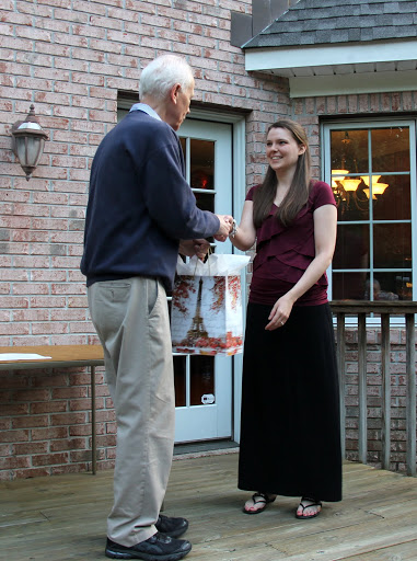 Savannah German accepts congratulations from Dr. Stephen Carls at the history department cookout on May 13, 2016, for her successful completion of a master's program in library science at Texas Woman's University.