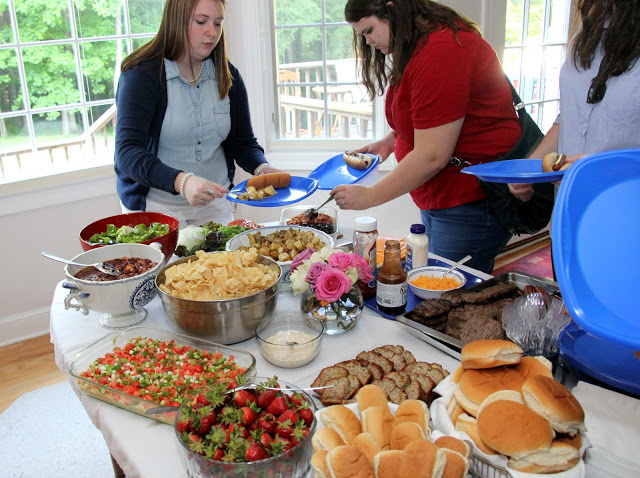Kathryn Mitchell (left) and Jessica Barton prepare their plates at the history department cookout on May 13, 2016.