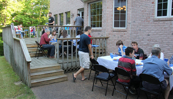 Attendees enjoy beautiful weather, great conversation, and good food at the 24th Annual Phi Alpha Theta/History Department Cookout at Dr. Stephen Carls's home on May 13, 2016.