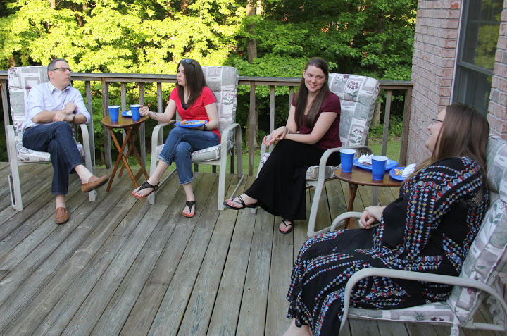 Attendees relax on the deck of Dr. Stephen Carls's home during the Phi Alpha Theta/History Department cookout on May 13, 2016. They are (left to right) Dr. Keith Bates, Caitlin Roach, Savannah German, and Hannah Conway.