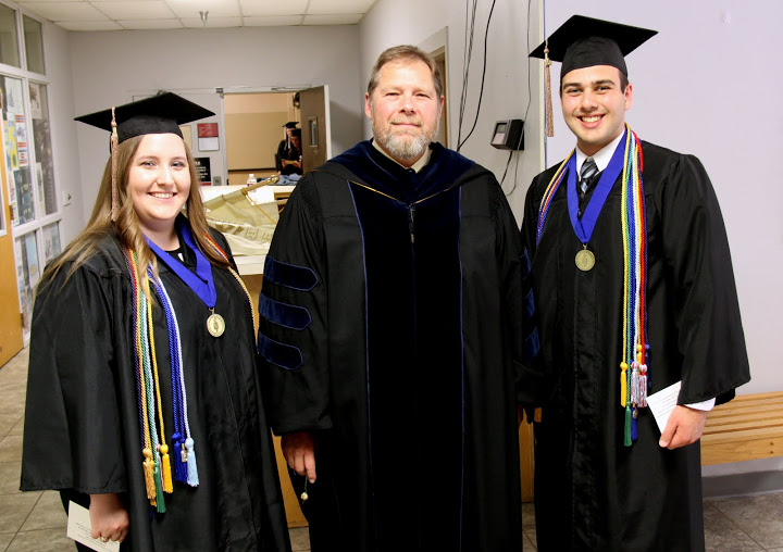 Dr. C. Ben Mitchell (center), Union University's provost, stands with Phi Alpha Theta members Hannah Conway and Allen Mitchell prior to Union's spring graduation on May 21, 2016.