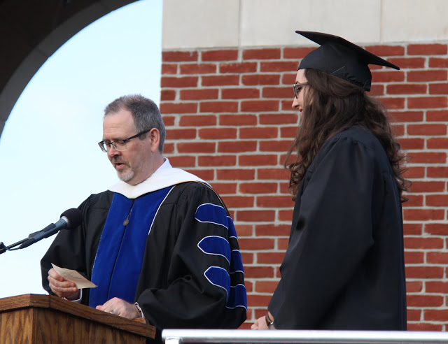 Dr. John Netland, Dean of the College of Arts and Sciences, reads Olivia Winters' name as the next recipient of a bachelor's degree at Union University's commencement exercises on May 21, 2016.