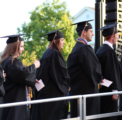 Hannah Conway (left) and Allen Bradley (second from right) wait in line to receive their diplomas at Union University's spring commencement services on May 21, 2016.