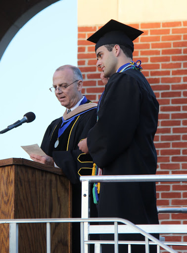 Dr. William Nance, Acting Dean of the School of Business Administration, reads the name of Allen Bradley to receive his bachelor's degree at Union University's commencement services on May 21, 2016.