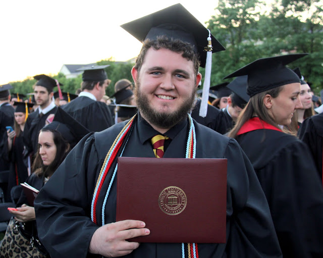 History major Nicholas Hancock proudly holds his diploma following the commencement services at Union University on May 21, 2016.