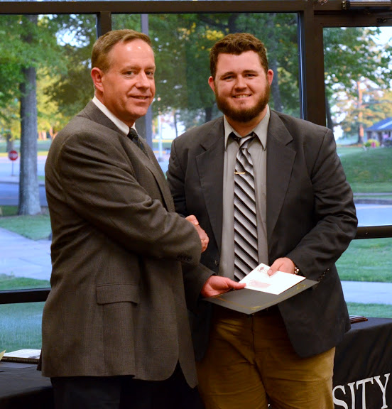 Dr. Henry Allen (left) congratulates Nicholas Hancock at the history awards banquet on May 5, 2016, for his third place award in the Dr. James Alex Baggett History Research Paper Competition. Photo by MiKalla Cotton