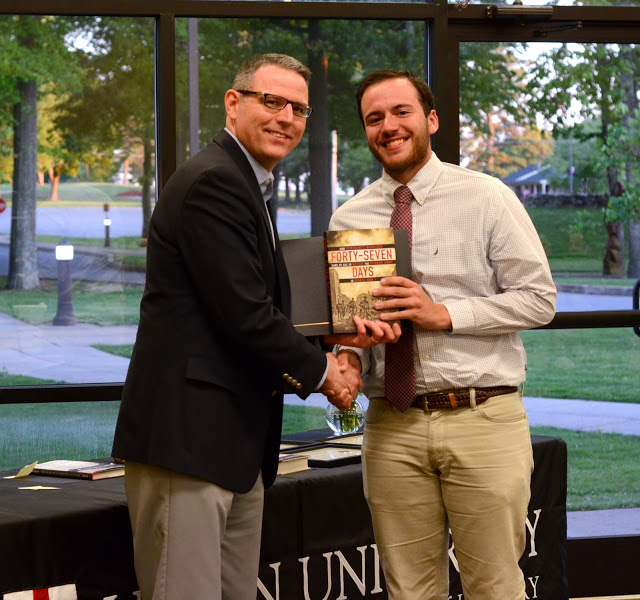 Dr. Keith Bates (left) presents a certificate of commendation and a book to Jeremy Ebert at the history awards banquet on May 5, 2016, for Jeremy's outstanding paper presentation at the Tennessee Phi Alpha Theta Regional Conference on April 2. Photo by MiKalla Cotton