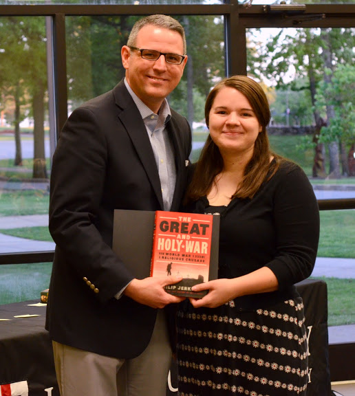 Dr. Keith Bates presents a certificate of commendation and a book to Jordan Sellers at the History Department Awards Banquet on May 5, 2016, for the excellent paper she presented at the Tennessee Phi Alpha Theta Regional Conference on April 2. Photo by MiKalla Cotton