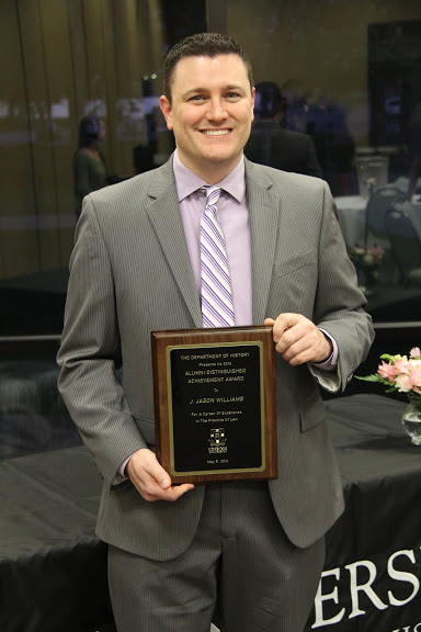 J. Jason Williams holds his History Alumni Distinguished Achievement Award following the history awards banquet on May 5, 2016.