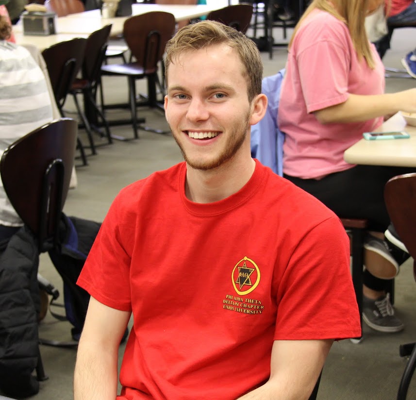 Delta-Psi Chapter President-elect Seth Reid proudly wears his Phi Alpha Theta T-shirt at lunch on March 13, 2017, which was the history department's History Spirit Day.
