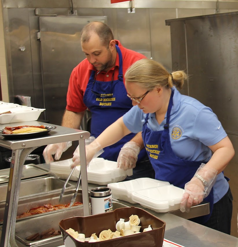 Rotarians Wayne Dredgers and Sabrina Young prepare takeout breakfast orders at the Jackson Old Hickory Rotary Club Pancake Breakfast on March 18, 2017.