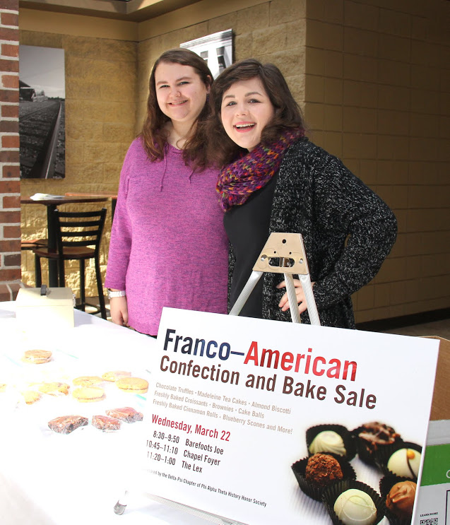 Delta-Psi chapter members Jessica Barton (left) and Priscilla Porter take care of the sales table near the Lexington Inn for the Phi Alpha Theta-sponsored Franco-American bake sale on March 22, 2017.