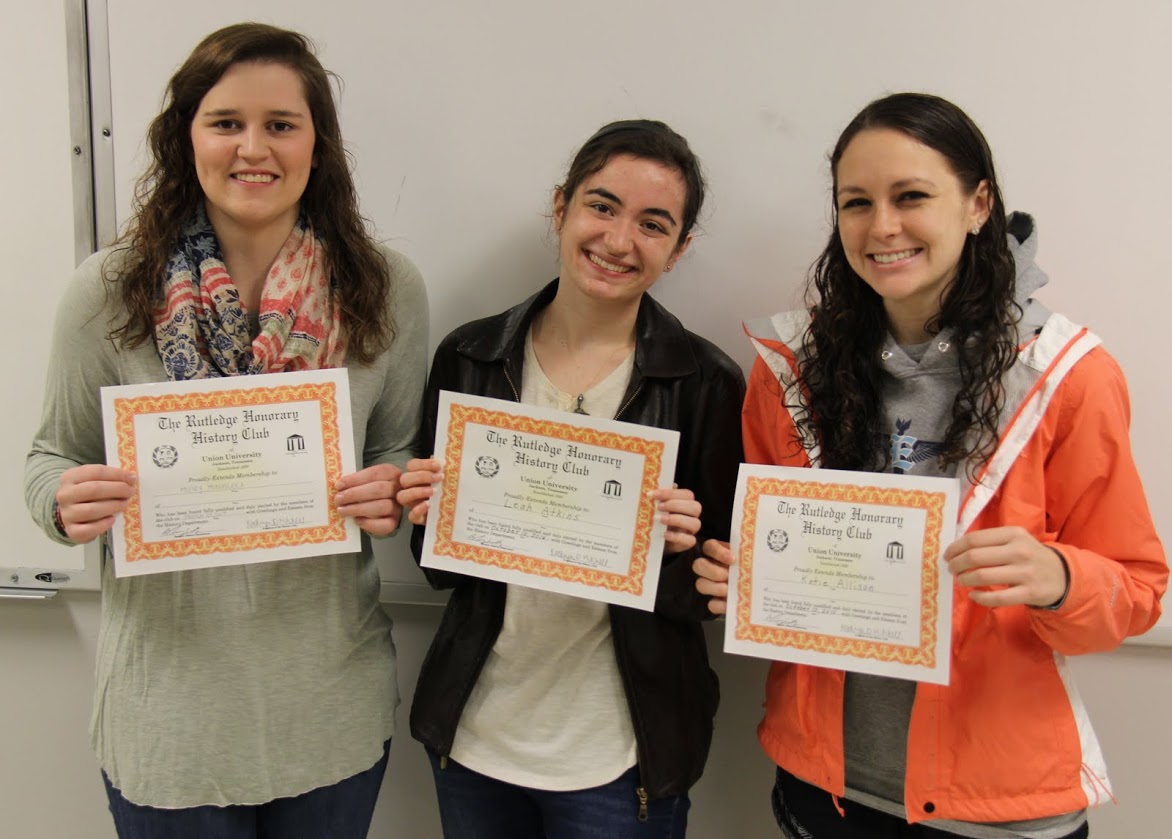 Haley Hathcock (left to right), Leah Atkins, and Katie Allison show off their certificates of membership following their induction into the Rutledge Honorary History Club on March 27, 2017.