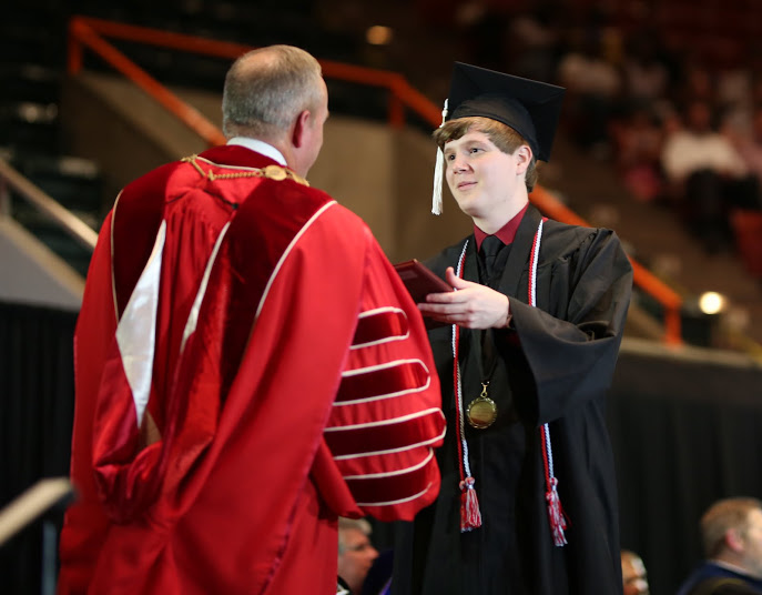 Phi Alpha Theta member Thomas Gray (right) accepts his diploma from Union University President Dr. Samuel W. Dub Oliver at the university's undergraduate commencement services on May 20, 2017. Photo by Kristi Woody