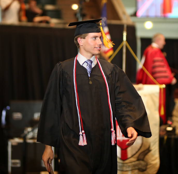 History major Stephen Lewoczko heads back to his seat after receiving his diploma at Union University's undergraduate commencement services on May 20, 2017. Photo by Kristi Woody