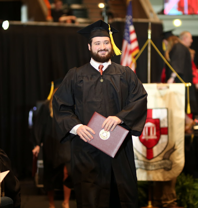 History major Luke Parrett proudly walks back to his seat after receiving his diploma at Union University's undergraduate commencement services on May 20, 2017. Photo by Kristi Woody