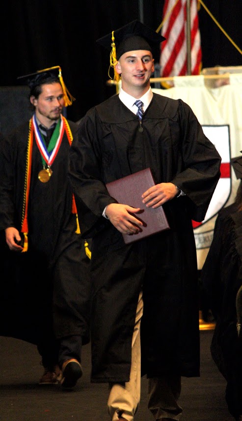 History major Jeff Williams (riight) heads back to his seat after receiving his diploma at Union's graduation exercises on May 20, 2017. Photo by Kristi Woody