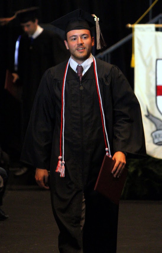 Jeremy Ebert, a history/business administration major, is delighted as he heads back to his seat after receiving his diploma at Union University's graduation services on May 20, 2017. Photo by Kristi Woody