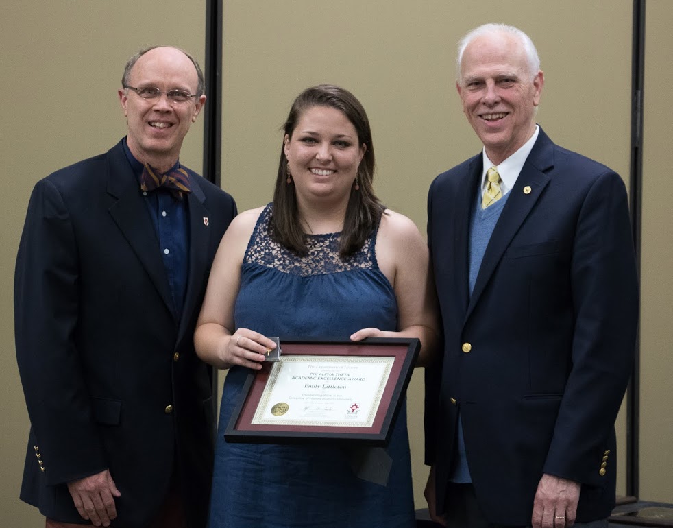 Emily Littleton accepts the Phi Alpha Theta Scholarship Pin and Academic Excellence Award from Robert Briley (left) and Dr. Stephen Carls at the history awards banquet on May 4, 2017. Photo by Janelle Vest