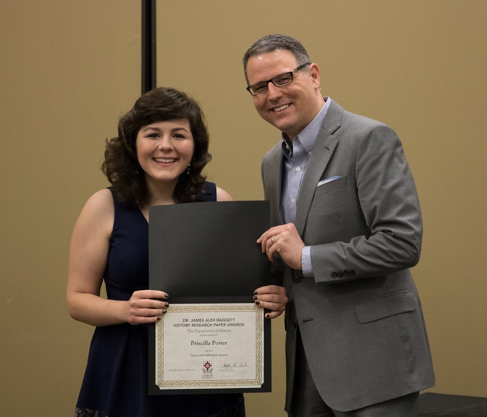 Priscilla Porter accepts the honorable mention certificate in the Dr. James Alex Baggett History Research Paper Competition from Dr. Keith Bates at the history awards banquet on May 4, 2017. Photo by Janelle Vest