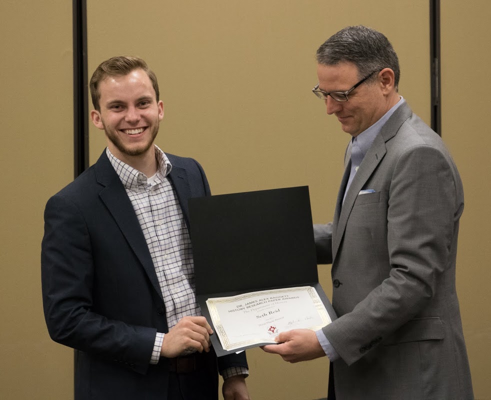 Seth Reid (left) accepts a third place award in the Dr. James Alex Baggett History Research Paper Competition from Dr. Keith Bates at the history awards banquet on May 4, 2017. Photo by Janelle Vest
